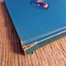 Close-up of a blue book corner on a textured surface