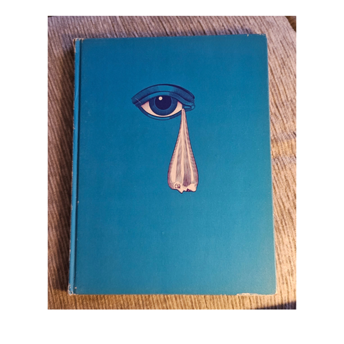Blue Hardback beatles illustrated lyrics book with a graphic of an eye crying 